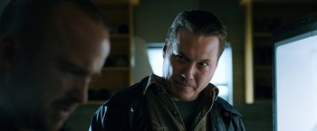 Movie still from “El Camino: A Breaking Bad Movie” (2019), directed by Vince Gilligan – A person wearing a jacket looking at the camera; Close Up shot, Low angle