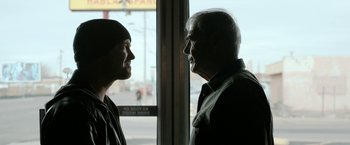 Movie still from “El Camino: A Breaking Bad Movie” (2019), directed by Vince Gilligan – A man and a woman looking at each other; Close Up shot, Over the shoulder angle