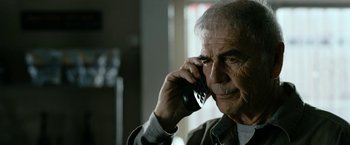 Movie still from “El Camino: A Breaking Bad Movie” (2019), directed by Vince Gilligan – An older man talking on a cell phone; Close Up shot, Over the shoulder angle