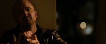 Movie still from “El Camino: A Breaking Bad Movie” (2019), directed by Vince Gilligan – A person wearing a leather jacket; Close Up shot, Low angle