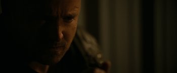 Movie still from “El Camino: A Breaking Bad Movie” (2019), directed by Vince Gilligan – A man holding a knife; Close Up shot, Over the shoulder angle