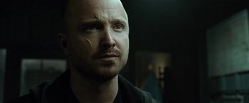 Movie still from “El Camino: A Breaking Bad Movie” (2019), directed by Vince Gilligan – A person looking at the camera; Close Up shot, Low angle