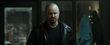 Movie still from “El Camino: A Breaking Bad Movie” (2019), directed by Vince Gilligan – A person wearing a leather jacket; Close Up shot, Low angle