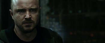 Movie still from “El Camino: A Breaking Bad Movie” (2019), directed by Vince Gilligan – A person wearing a black t - shirt; Close Up shot, Over the shoulder angle