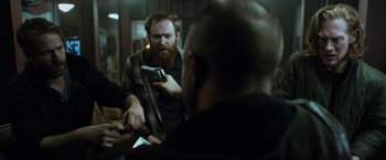 Movie still from “El Camino: A Breaking Bad Movie” (2019), directed by Vince Gilligan – A man with a beard is talking to another man; Medium shot, Over the shoulder angle