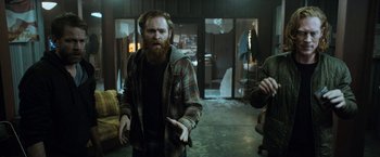 Movie still from “El Camino: A Breaking Bad Movie” (2019), directed by Vince Gilligan – A man with a beard is standing in an empty room; Medium shot, Over the shoulder angle