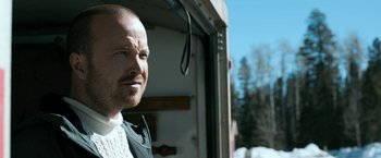 Movie still from “El Camino: A Breaking Bad Movie” (2019), directed by Vince Gilligan – A man standing next to a truck on the side of a road; Close Up shot, Low angle