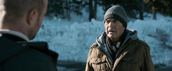 Movie still from “El Camino: A Breaking Bad Movie” (2019), directed by Vince Gilligan – An older man wearing a winter hat and jacket; Close Up shot, Over the shoulder angle