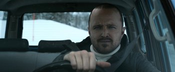 Movie still from “El Camino: A Breaking Bad Movie” (2019), directed by Vince Gilligan – A person driving a car; Close Up shot, Low angle