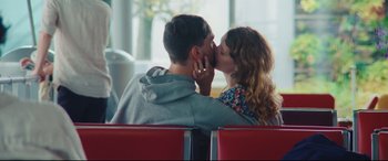 Movie still from “Everybody Loves Jeanne” (2022), directed by Céline Devaux – A man and a woman kissing on a bench; Medium shot, Over the shoulder angle