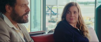 Movie still from “Everybody Loves Jeanne” (2022), directed by Céline Devaux – A woman sitting next to another woman in a chair; Close Up shot, Over the shoulder angle