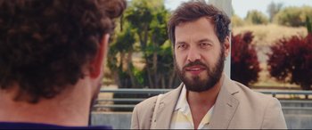 Movie still from “Everybody Loves Jeanne” (2022), directed by Céline Devaux – A man with a beard talking to another man; Close Up shot, Over the shoulder angle