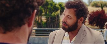 Movie still from “Everybody Loves Jeanne” (2022), directed by Céline Devaux – A man with a beard talking to another man outside; Close Up shot, Over the shoulder angle