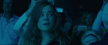 Movie still from “Everybody Loves Jeanne” (2022), directed by Céline Devaux – A person with long brown hair; Close Up shot, Over the shoulder angle