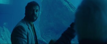 Movie still from “Everybody Loves Jeanne” (2022), directed by Céline Devaux – A man standing in front of an underwater cave; Medium shot, Over the shoulder angle