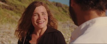 Movie still from “Everybody Loves Jeanne” (2022), directed by Céline Devaux – A person with a beard smiling; Close Up shot, Over the shoulder angle