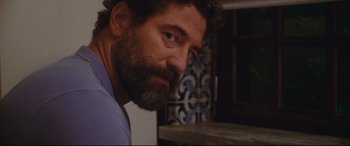 Movie still from “Everybody Loves Jeanne” (2022), directed by Céline Devaux – A person with a beard; Close Up shot, Over the shoulder angle