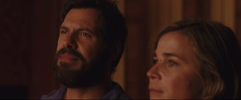 Movie still from “Everybody Loves Jeanne” (2022), directed by Céline Devaux – A man and a woman looking at the camera; Close Up shot, Over the shoulder angle