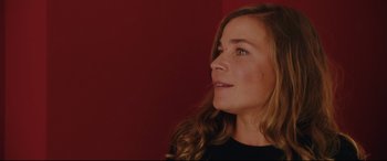 Movie still from “Everybody Loves Jeanne” (2022), directed by Céline Devaux – A beautiful woman with long hair looking to the side; Close Up shot, Low angle