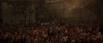Movie still from “Evita” (1996), directed by Alan Parker – A large crowd of people gathered in the street; Extreme Wide shot, High angle