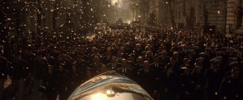 Movie still from “Evita” (1996), directed by Alan Parker – A large crowd of people in suits and ties; Wide shot, High angle