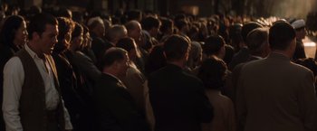 Movie still from “Evita” (1996), directed by Alan Parker – A group of people standing in a room; Wide shot, High angle
