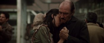 Movie still from “Evita” (1996), directed by Alan Parker – An older man and a younger woman embracing; Close Up shot, High angle