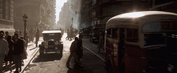 Movie still from “Evita” (1996), directed by Alan Parker – A busy city street filled with lots of traffic; Extreme Wide shot, High angle