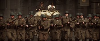 Movie still from “Evita” (1996), directed by Alan Parker – A group of men in military uniforms holding guns; Wide shot, High angle