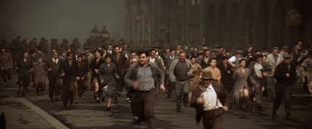 Movie still from “Evita” (1996), directed by Alan Parker – A group of people walking down a street; Extreme Wide shot, High angle