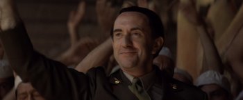 Movie still from “Evita” (1996), directed by Alan Parker – A person wearing a military uniform; Close Up shot, Low angle