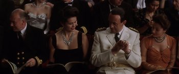 Movie still from “Evita” (1996), directed by Alan Parker – A man and a woman sitting next to each other; Medium shot, High angle