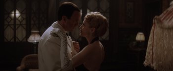 Movie still from “Evita” (1996), directed by Alan Parker – A man and a woman are dancing together in the dark; Medium shot, Low angle