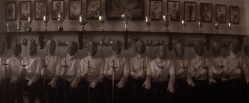 Movie still from “Evita” (1996), directed by Alan Parker – A group of people in white shirts and black pants with swords; Wide shot, Low angle