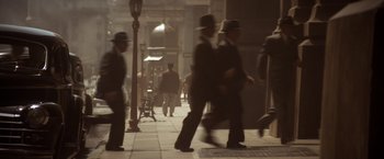 Movie still from “Evita” (1996), directed by Alan Parker – A group of people walking down a street; Extreme Wide shot, High angle