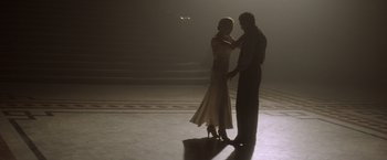 Movie still from “Evita” (1996), directed by Alan Parker – A man and a woman are dancing in the dark; Wide shot, Low angle
