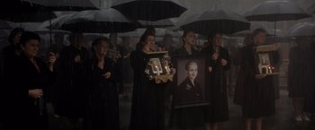 Movie still from “Evita” (1996), directed by Alan Parker – A group of women holding candles and a portrait; Medium shot, High angle