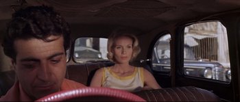 Movie still from “Exodus” (1960), directed by Otto Preminger – A woman sitting in the back seat of a car; Close Up shot, Low angle