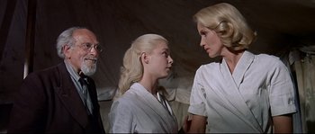 Movie still from “Exodus” (1960), directed by Otto Preminger – A group of people standing next to each other in a room; Medium shot, Low angle