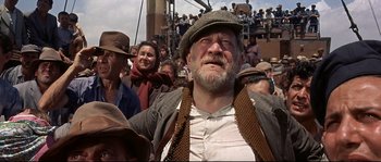 Movie still from “Exodus” (1960), directed by Otto Preminger – An old man with a beard wearing a hat; Medium shot, Low angle