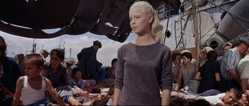 Movie still from “Exodus” (1960), directed by Otto Preminger – A woman standing in front of a group of people; Medium shot, Low angle