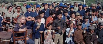 Movie still from “Exodus” (1960), directed by Otto Preminger – A large group of young people are gathered together for an event; Medium shot, High angle
