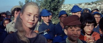 Movie still from “Exodus” (1960), directed by Otto Preminger – A group of young people wearing blue hats and holding musical instruments; Close Up shot, Low angle