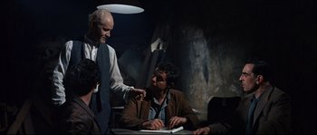 Movie still from “Exodus” (1960), directed by Otto Preminger – Two men and a woman sitting at a table; Medium shot, Over the shoulder angle