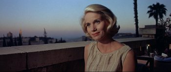 Movie still from “Exodus” (1960), directed by Otto Preminger – A woman with blonde hair is standing on a balcony; Close Up shot, Low angle