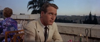 Movie still from “Exodus” (1960), directed by Otto Preminger – A person wearing a suit and tie; Close Up shot, Low angle