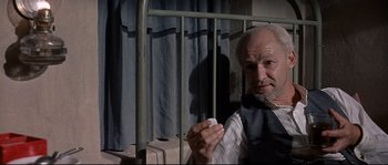 Movie still from “Exodus” (1960), directed by Otto Preminger – An older man holding a white ball in his hand; Close Up shot, High angle