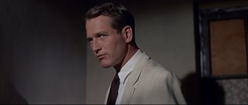 Movie still from “Exodus” (1960), directed by Otto Preminger – A man in a suit and a tie; Close Up shot, Over the shoulder angle