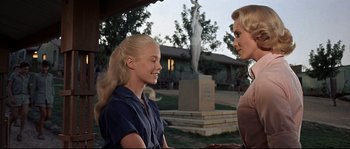 Movie still from “Exodus” (1960), directed by Otto Preminger – Two women talking in front of a statue of a woman; Medium shot, Over the shoulder angle