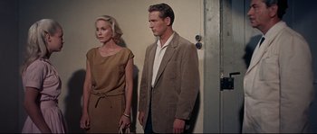 Movie still from “Exodus” (1960), directed by Otto Preminger – A man and a woman standing next to each other; Medium shot, High angle